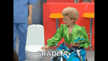 a woman in a green top sits on a toilet with the words grade a+ written on the bottom