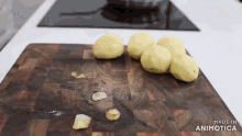 potatoes on a wooden cutting board that says made in animatica on the bottom