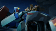 two transformers are sitting in a car and one has the word transformers on it