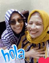two women are posing for a picture with the word hola written on the bottom