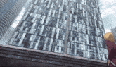 a woman stands on the edge of a building looking up at the sky