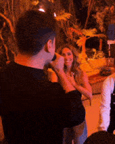 a man holds a microphone in front of a woman