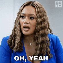 a woman wearing a blue jacket says oh yeah