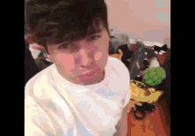 a man is taking a selfie in a messy room .