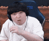 a man wearing headphones is sitting in a chair that says secret lab on it