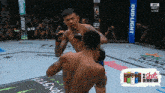 two men are fighting in a boxing ring with a bud light sign in the background