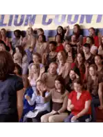 a large group of people are sitting in front of a banner that says lion county