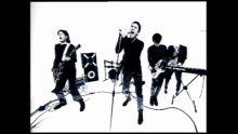 a black and white photo of a band playing instruments