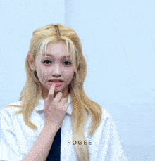 a girl with blonde hair is wearing a white shirt and a black tie ..