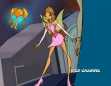 a woman in a pink dress is standing in front of a wcd channel logo