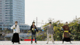 a group of men are standing in front of a building with a yellow caution tape around their waists