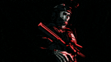 a skeleton holding a rifle with a red light behind him