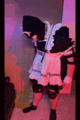 a person in a maid costume is standing next to a yellow box