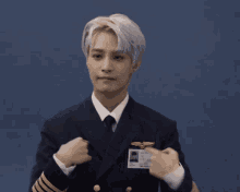 a man in a navy uniform has a name tag that says ' shawn ' on it