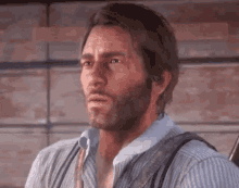 a man with a beard and suspenders is looking at the camera .