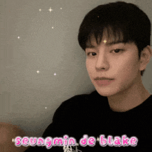 a close up of a young man with the name seungmin de blake on the bottom