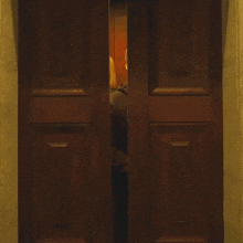 a man and a woman are standing in a doorway and the man is wearing a black shirt