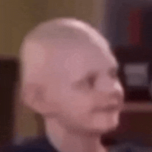 a close up of a baby 's head with a bald head .