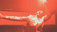 a photo of a man in a red shirt with the name the maw on the bottom