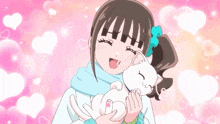 a girl holding a white cat in her arms with hearts in the background