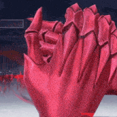 a close up of a red glove with sharp nails