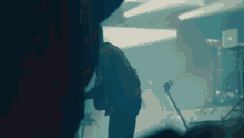 a close up of a person 's hands playing a guitar in a dark room .
