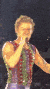 a blurry picture of a man singing into a microphone on a stage