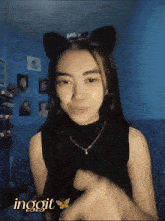 a girl wearing a cat ear headband with the word ingoit written on it