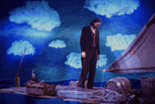 a man in a suit is standing on a raft with a lighthouse in the background