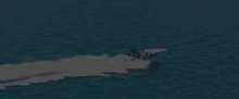 a man wearing sunglasses and a hat is riding a boat in the water
