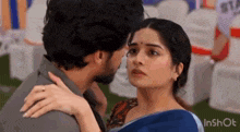 a man and a woman are kissing and hugging each other