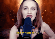 a woman is singing into a microphone with the words rey where u at
