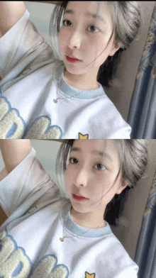 a girl taking a selfie with a shirt that says m on it