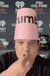 a man wearing a pink hat that says rumb