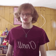 a man wearing glasses and a t-shirt that says ' miss o '