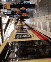 a yellow and red train with the letter s on the door