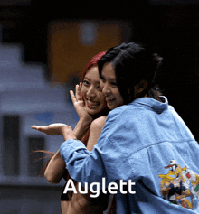 a picture of two girls hugging with the name auglett on the bottom