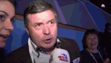 a man wearing a microphone that says abto radio