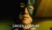 a close up of a man wearing a black mask with the words groza cosplay written below him