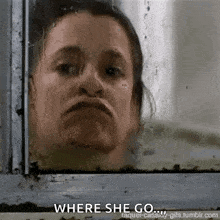 a woman is looking out of a window with the words `` where she go '' written below her .