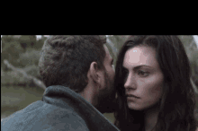 a man kissing a woman on the forehead in a close up