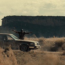 a man jumps out of a car that says " red guardian "