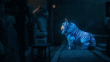 a statue of a blue tiger is floating in the air
