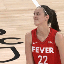 a female basketball player wearing a red jersey with the number 22 on it
