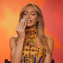 a woman in a yellow top with rhinestones on it