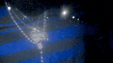 a blurred image of a blue and white striped cloth with a light shining on it
