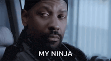 a man with a beard and hat is sitting in a car and says `` my ninja '' .