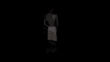 a person is holding a small black and white dog in their hand in the dark .