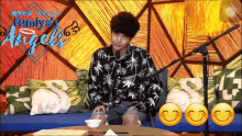 a man is sitting in front of a microphone with the word angels on the bottom