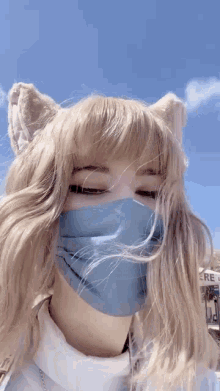 a girl wearing a blue mask and cat ears .